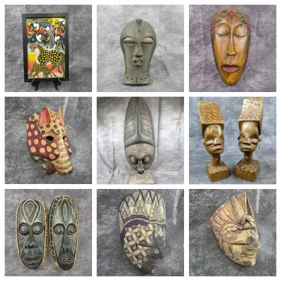 Collection of carved wooden African and global tribal art pieces, including decorative masks, figurines, and a framed Tingatinga-style...