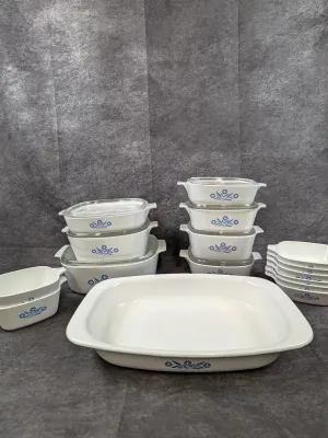 Vintage CorningWare Cornflower Blue pattern casserole dishes, baking pans, and small dishes, many with glass lids.