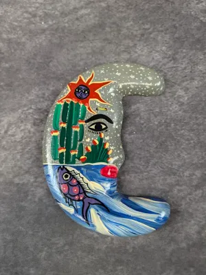 Hand-painted crescent moon wall ornament featuring surreal celestial, desert cactus, and aquatic imagery.