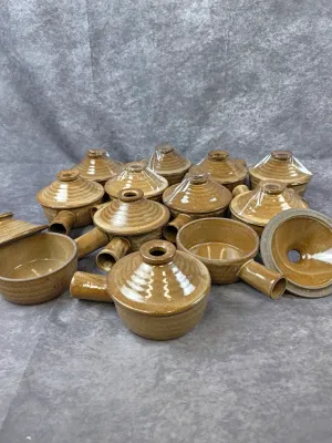 Collection of vintage studio pottery French onion soup bowls with lids and handles, featuring a speckled brown glaze.
