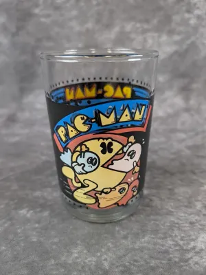 Vintage Pac-Man collector's drinking glass featuring colorful arcade game graphics, circa 1980s.