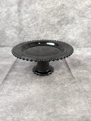 Vintage black milk glass pedestal cake stand featuring a beaded hobnail-style rim and base.