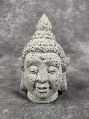 Carved stone Buddha head sculpture featuring textured grey speckled stone with ornate topknot detailing.