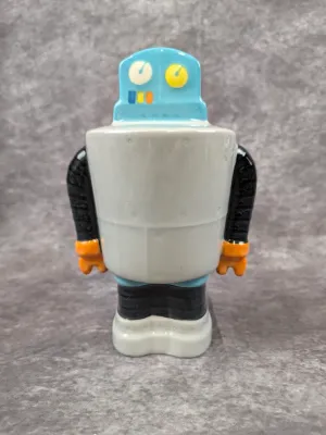 Vintage-style ceramic robot figurine featuring a light blue head with dial details, a grey body, black arms, and orange hands.