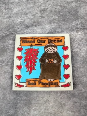 Vintage San Pasqual ceramic tile trivet featuring a "Bless Our Bread" design with a monk, chili ristra, and red hearts.