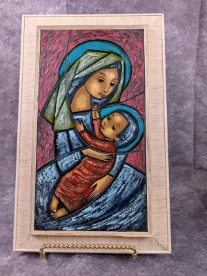 Mid-century modern enamel-on-copper plaque depicting the Madonna and Child, presented in a textured fabric-lined wooden frame.