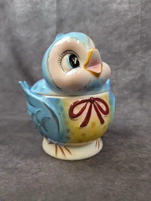 Vintage Lefton bluebird ceramic cookie jar. featuring hand-painted details and a red bow, circa 1950s.