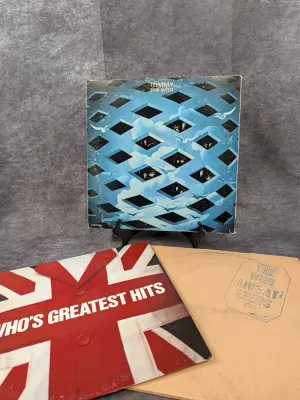 Trio of classic rock vinyl albums by The Who, including 'Tommy', 'Who's Greatest Hits', and 'Live at...