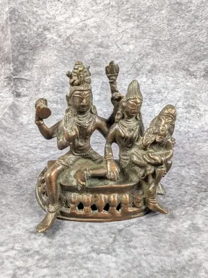 Antique Indian bronze Somaskanda idol featuring Shiva, Parvati, and baby Ganesha with an aged patina.