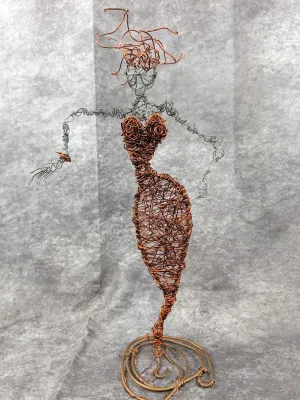 Handmade mixed metal wire sculpture depicting a female figure in a fitted gown, crafted from copper and silver-toned wire.