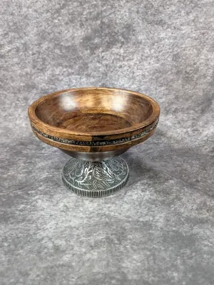 Small turned wooden pedestal bowl featuring an ornate, embossed metal base and matching metal inlay band around the rim.
