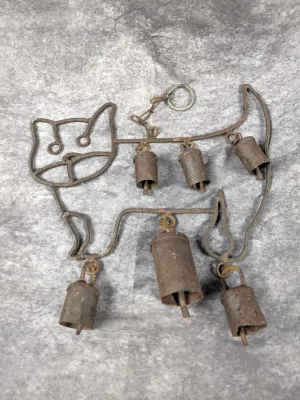 Rustic wrought iron cat-shaped wind chime featuring suspended metal bells, showing a weathered, patinated finish.