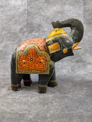 Hand-painted wooden elephant figurine featuring traditional Indian-style floral patterns and decorative saddle detailing.