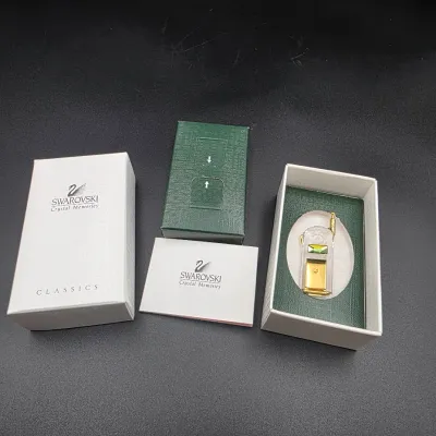 Swarovski Crystal Memories miniature mobile phone figurine with gold-tone accents, complete with original box and paperwork.