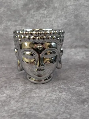 Small ceramic Buddha head planter or candle holder with a reflective metallic silver glaze.