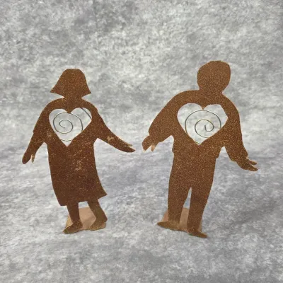 Pair of rusted metal couple figurines featuring heart cutout photo holders with wire spirals.