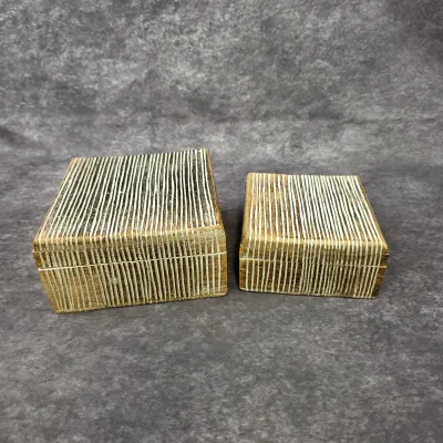 Pair of decorative wooden trinket boxes featuring a textured, hand-carved linear pattern with white inlay.