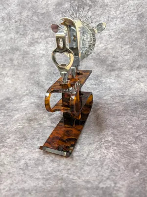 Vintage mid-century modern bar tool set featuring a faux-tortoiseshell acrylic stand holding a stainless steel bottle opener, bar knife,...