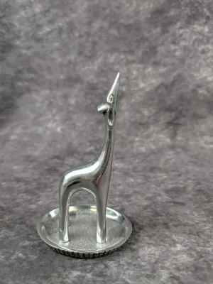 Vintage silver-tone metal giraffe ring holder on a small circular tray base, featuring a stylized mid-century modern design.