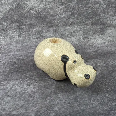 Vintage crackle-glaze ceramic hippopotamus planter, featuring black painted details and a top opening for small flora.