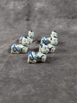 Set of five miniature blue and white Chinese porcelain crawling baby figurines or chopstick rests.