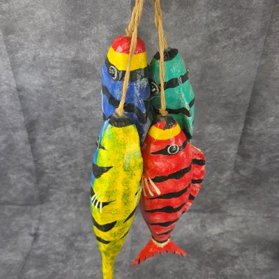 Hand-carved and painted wooden fish hanging decor, featuring four brightly colored fish suspended from jute twine.