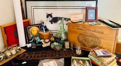 Assortment of vintage collectibles and decor, including a wooden mancala board, stained glass figurines, a Beringer Chardonnay wooden...