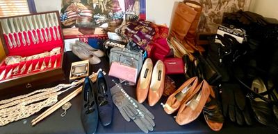 Assortment of vintage women's shoes, leather gloves, accessories, and a wooden chest containing a silver-plated flatware set.