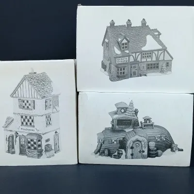 LOT 124: Department 56 Dickens' Village Series Nicholas Nickleby Cottage, Peggoty's Seaside Cottage and Poulterer