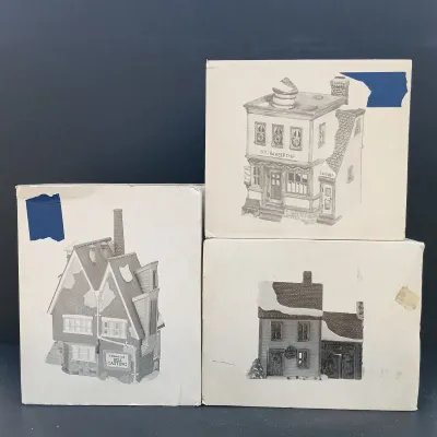 LOT 135: Department 56 New England Village Series Yankee Jud Bell Casting, Livery Stable & Boot Shop and Ben's Barber Shop