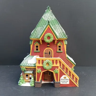 LOT 134: Department 56 North Pole Series Santa's Rooming House, Neenee's Dolls & Toys, and End of the Line