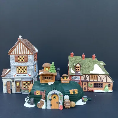 LOT 124: Department 56 Dickens' Village Series Nicholas Nickleby Cottage, Peggoty's Seaside Cottage and Poulterer