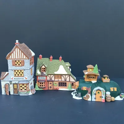 LOT 124: Department 56 Dickens' Village Series Nicholas Nickleby Cottage, Peggoty's Seaside Cottage and Poulterer