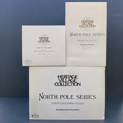 LOT 134: Department 56 North Pole Series Santa's Rooming House, Neenee's Dolls & Toys, and End of the Line
