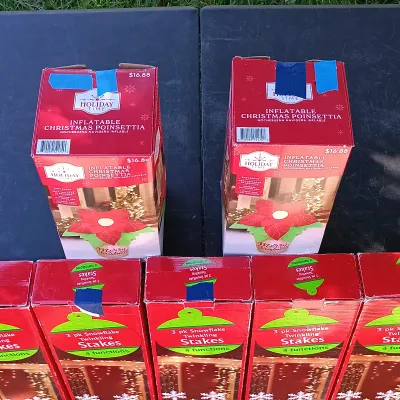 LOT 120: Pair of 4ft Inflatable Christmas Poinsettas with (5) 3-Packs of Snowflake Twinkling Stakes