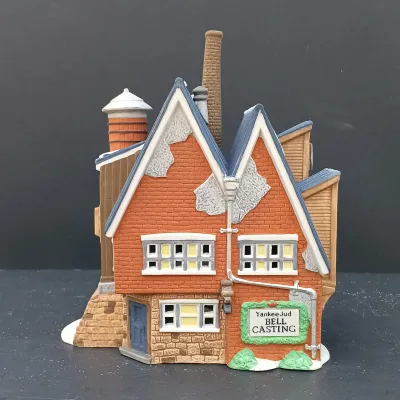 LOT 135: Department 56 New England Village Series Yankee Jud Bell Casting, Livery Stable & Boot Shop and Ben's Barber Shop