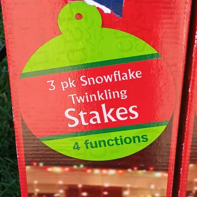 LOT 120: Pair of 4ft Inflatable Christmas Poinsettas with (5) 3-Packs of Snowflake Twinkling Stakes