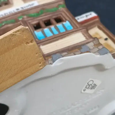 LOT 135: Department 56 New England Village Series Yankee Jud Bell Casting, Livery Stable & Boot Shop and Ben's Barber Shop
