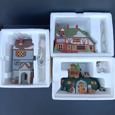 LOT 124: Department 56 Dickens' Village Series Nicholas Nickleby Cottage, Peggoty's Seaside Cottage and Poulterer