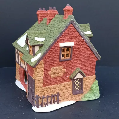 LOT 124: Department 56 Dickens' Village Series Nicholas Nickleby Cottage, Peggoty's Seaside Cottage and Poulterer