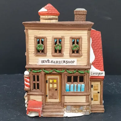 LOT 135: Department 56 New England Village Series Yankee Jud Bell Casting, Livery Stable & Boot Shop and Ben's Barber Shop
