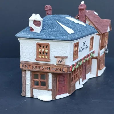 LOT 128: Department 56 Dickens Village Series The Old Curiosity Shop and Geo Weeton Watchmaker with New England Village Series Nathaniel...