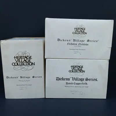 LOT 124: Department 56 Dickens' Village Series Nicholas Nickleby Cottage, Peggoty's Seaside Cottage and Poulterer