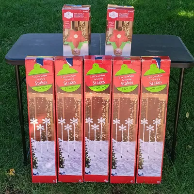LOT 120: Pair of 4ft Inflatable Christmas Poinsettas with (5) 3-Packs of Snowflake Twinkling Stakes