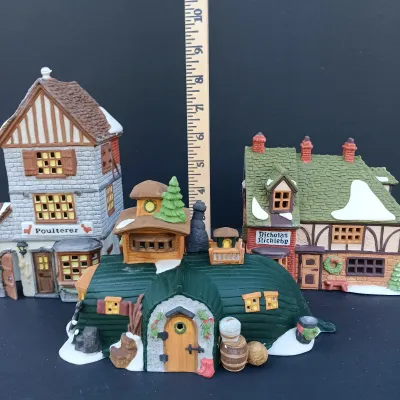 LOT 124: Department 56 Dickens' Village Series Nicholas Nickleby Cottage, Peggoty's Seaside Cottage and Poulterer