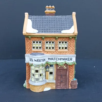 LOT 128: Department 56 Dickens Village Series The Old Curiosity Shop and Geo Weeton Watchmaker with New England Village Series Nathaniel...