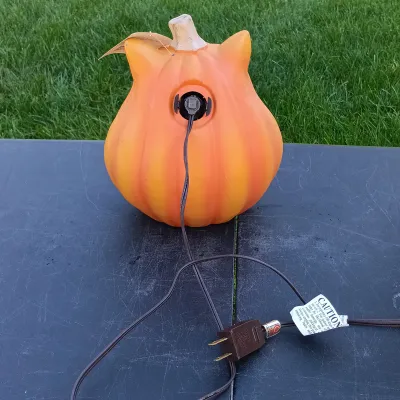 LOT 109: Inflatable 6ft Grave Stones, Light-Up Owl Pumpkin and Plastic Skeletons