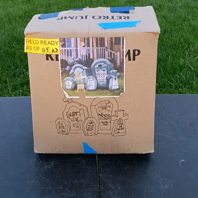 LOT 109: Inflatable 6ft Grave Stones, Light-Up Owl Pumpkin and Plastic Skeletons