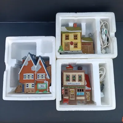 LOT 135: Department 56 New England Village Series Yankee Jud Bell Casting, Livery Stable & Boot Shop and Ben's Barber Shop