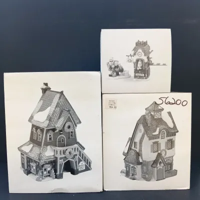 LOT 134: Department 56 North Pole Series Santa's Rooming House, Neenee's Dolls & Toys, and End of the Line